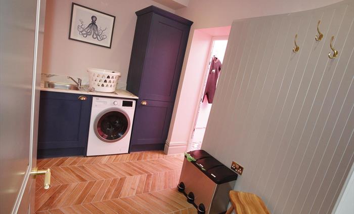 situated on the ground floor, washer dryer, sink, access to rear.